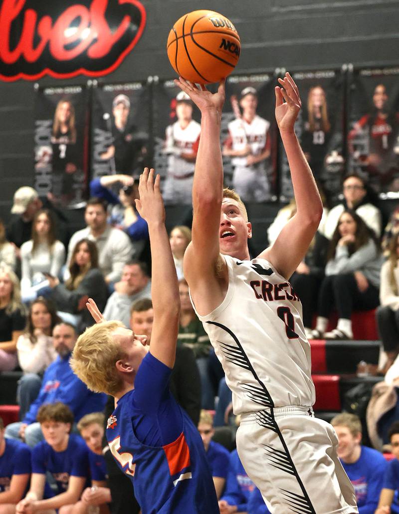 Indian Creek's Everett Willis shoots over Genoa-Kingston's Blake Ides during their game Friday, Jan. 3, 2025, at Indian Creek High School in Shabbona.