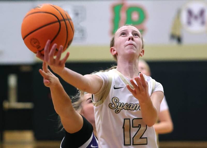 Sycamore's Sadie Lang gets to the basket ahead of a Rochelle defender during their game Friday, Dec. 6, 2024, at Sycamore High School.