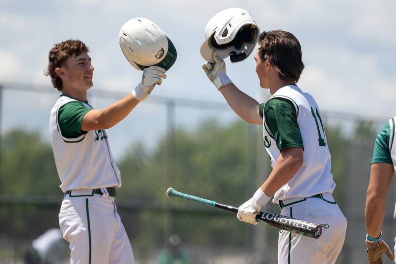 (11) Aj Hermes of St. Bede bumps helmet with teammate (2) Gus Burr after hitting home run on Saturday, May 24, 2025 at Stark County High School in Toulon.