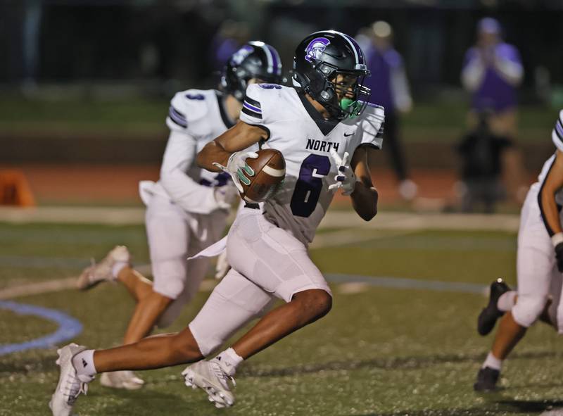 Downers Grove North's Tavarez Edwards (6) runs the ball during the varsity football game between Downers Grove North and York on Friday, Oct. 4, 2024 in Elmhurst.