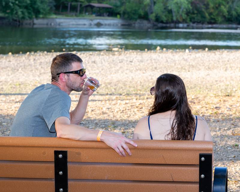 Gordon Henshaw enjoys a beer while talking to his wife Katrina at the Brew at the Bridge event. Sept 21, 2024 in Oswego.