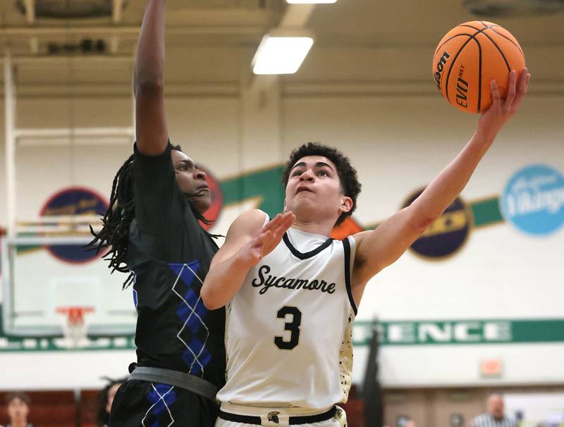 Sycamore's Marcus Johnson goes to the basket against Woodstock's Marc Thomas Friday, Feb. 27, 2026, during their IHSA Class 3A boys basketball regional championship game at Boylan Catholic High School in Rockford.