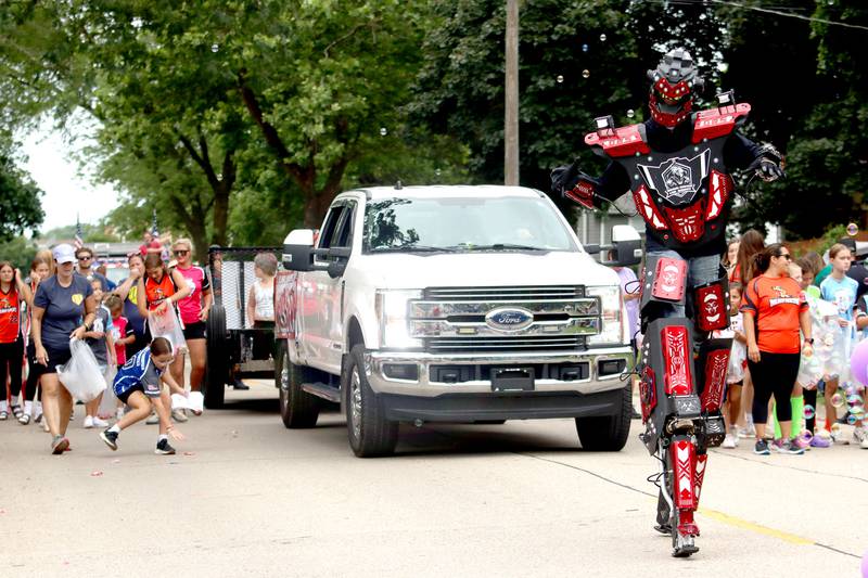 Head-Rush the LED Robot makes an appearance during the Fiesta Days Parade down Main Street in McHenry on Sunday, July 20, 2025.