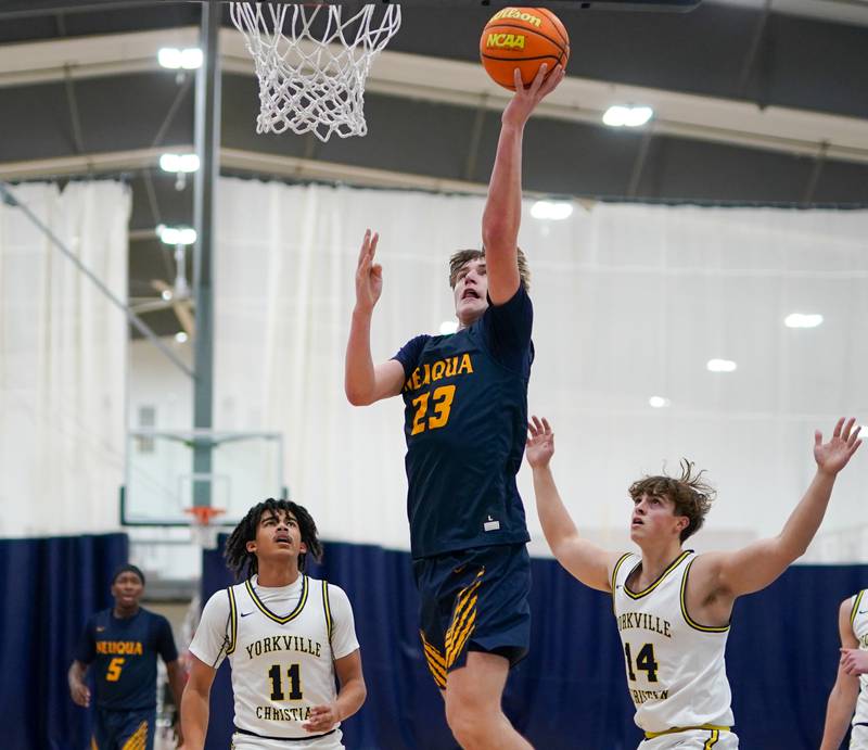 Neuqua Valley's Cole Kelly (23) drives to the hoop against Yorkville Christian's Kayden Maxwell (11) and Sam Painter (14) during a basketball game at Yorkville Christian High School on Tuesday, February 4, 2025.
