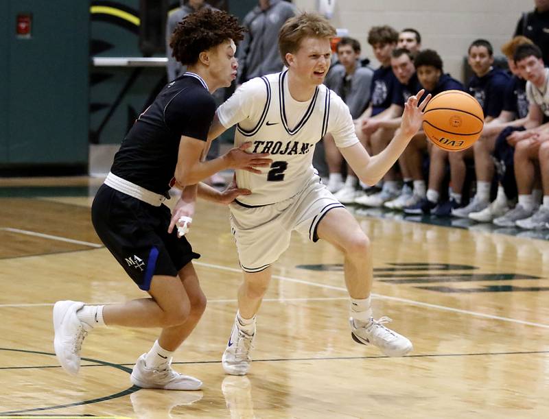 Cary-Grove's AJ Berndt (right) brings the ball up the court against Marmion's Caden Anderson during an IHSA Class 3A Crystal Lake South Regional boys basketball semifinal game on Wednesday, February, 25, 2026, at Crystal Lake South High School.
