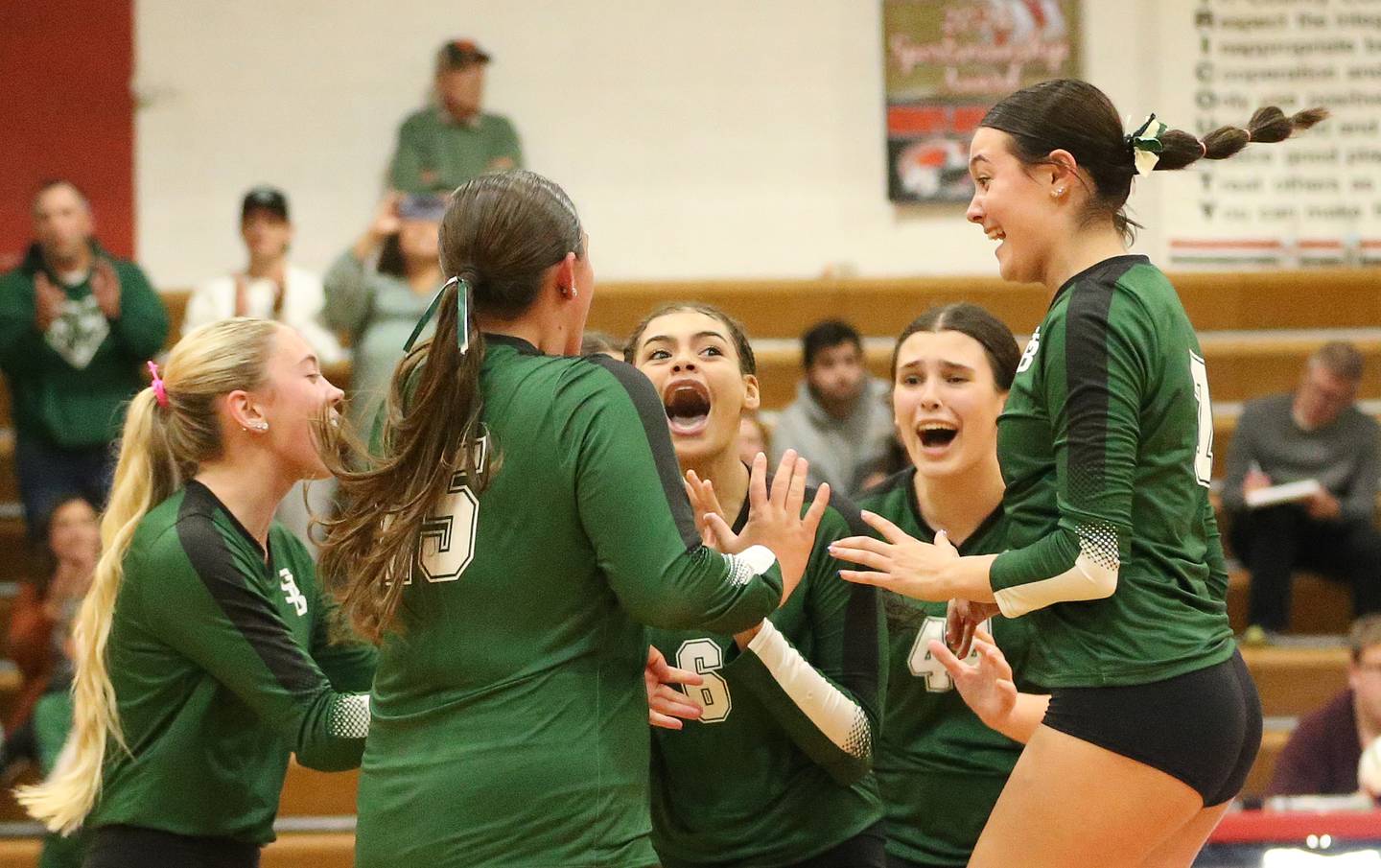 Members of the St. Bede volleyball team react after pulling off a upset over Henry-Senachwine on Tuesday, Oct. 21, 2025 at Henry-Senachwine High School.