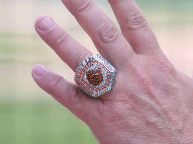 An Illinois Valley Pistol Shrimp staff member, wears a Prospect League Championship ring to the game during the Illinois Valley Pistol Shrimp home opener on Friday, May 30, 2025 at Schweickert Stadium in Peru.