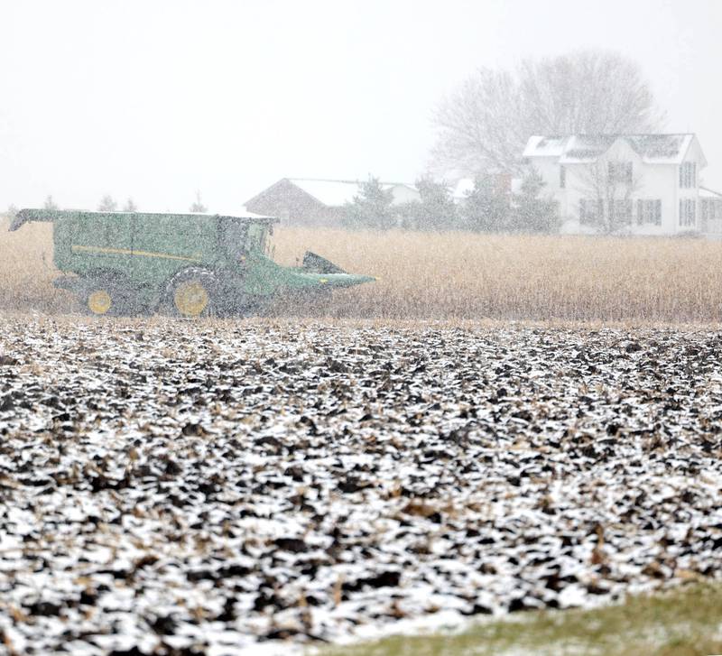 A combine sits idle as the snow falls Tuesday, Nov. 15, 2022, on a farm on McGirr Road just north of Hinckley. Tuesday was the first measurable snowfall in DeKalb County this season.