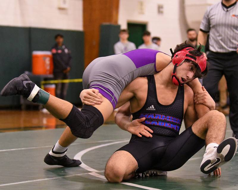 Zach Stewart of Marmion Academy, right, keeps a hand on Caden Chiarelli of Downers Grove North during the 138 weight class regional title match where Zach took the win on Saturday Feb. 3, 2024 held at Glenbard West High School.