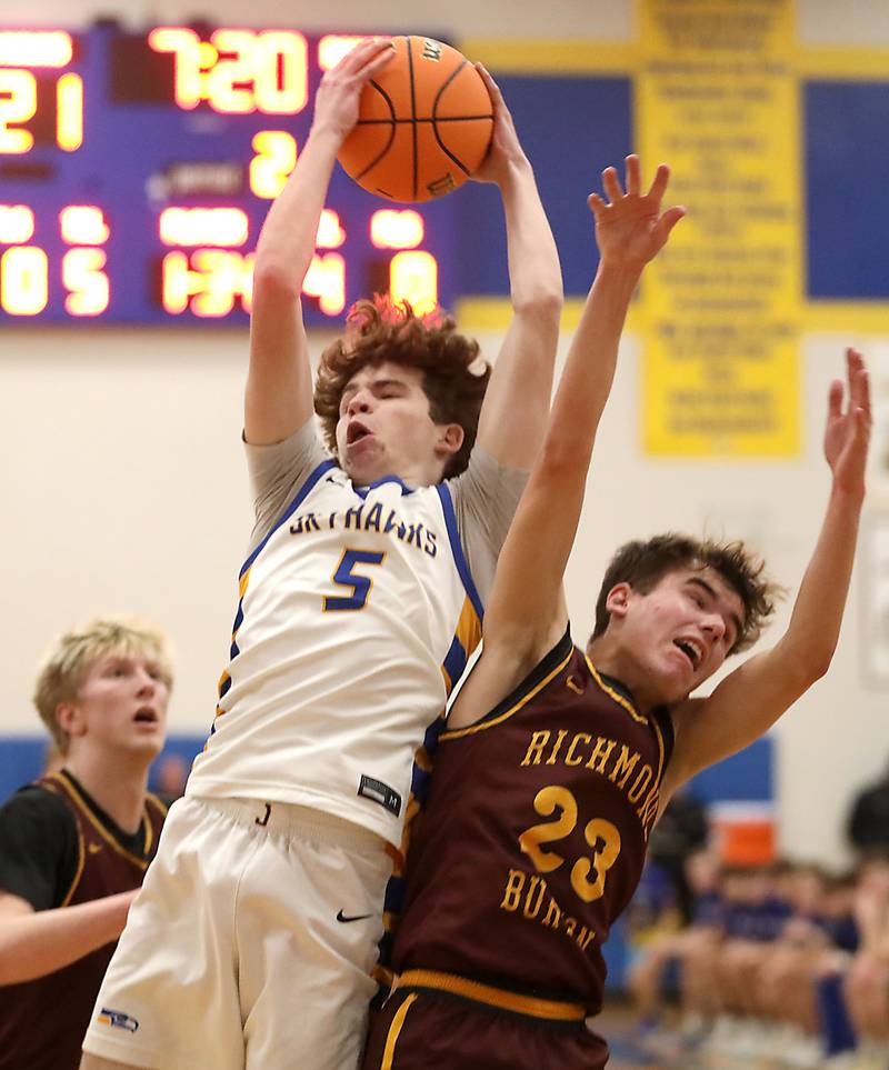 Johnsburg's Jacob Vetter grabs a rebound against Richmond-Burton's William Gardner during the IHSA Class 2A Johnsburg Regional Championship boys basketball game on Friday, February, 27, 2026, at Johnsburg High School.