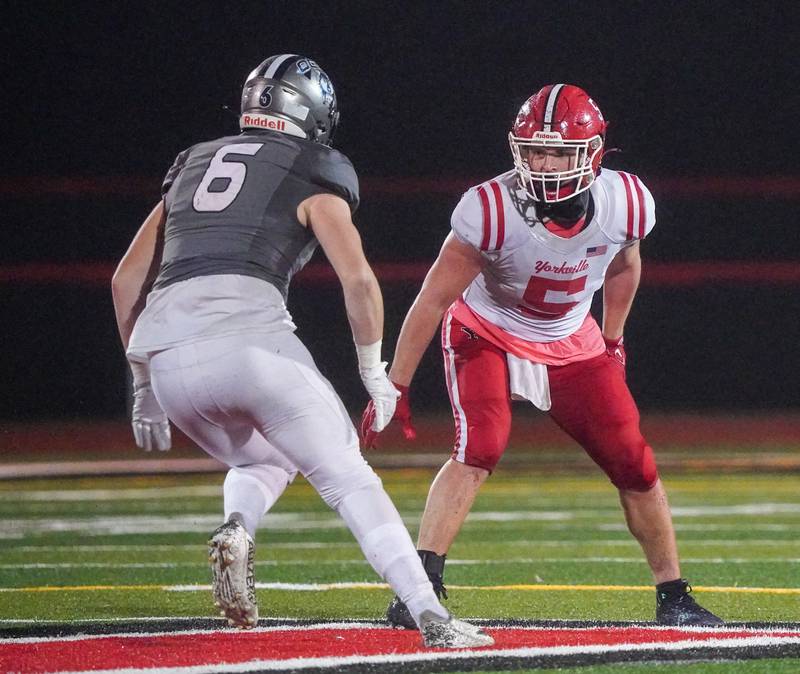 Yorkville's Ben Alvarez (5) defends against Oswego East's Aiden Moriarty (6) during a football game at Yorkville High School on Friday, Oct. 13, 2023.