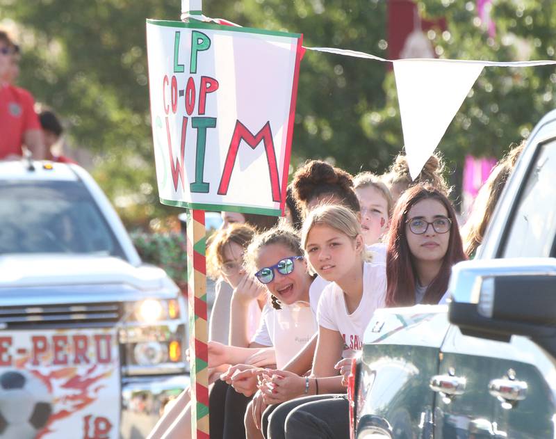 Members of the L-P Co-op girls swimming team ride on a float during the L-P Homecoming parade on Thursday, Oct. 5, 2023 downtown La Salle.