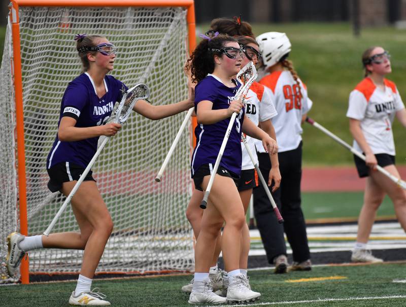 Emma Enright (middle) gets a pat on the back from teammate Ashley Poquette after scoring a goal to pull Downers Grove North within two points of Crystal Lake late in the Benet Supersectional game on June 3, 2025 at College of DuPage in Glen Ellyn.