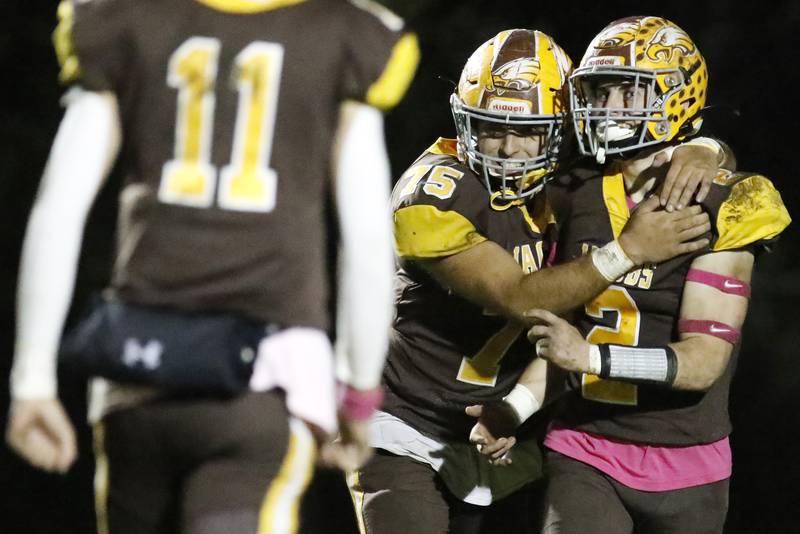 Jacobs' Kyle Koziel, center, hugs teammate Benjamin Ludlum after Ludlum's touchdown against Hampshire during their football game at Jacobs High School on Friday, Oct. 15, 2021 in Algonquin.