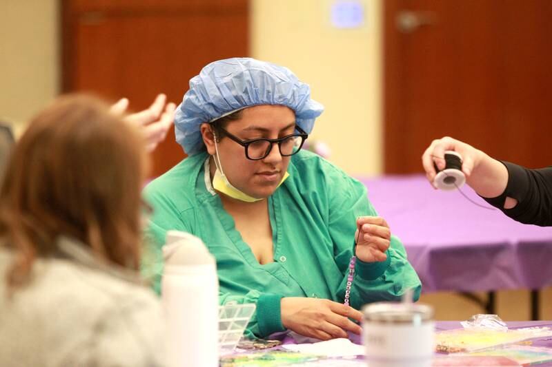 Aide Florian makes a friendship bracelet as part of Northwestern Medicine Central DuPage Hospital’s National Nurses Week activities in Winfield on Monday, May 6, 2024.