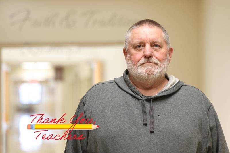 Dave Douglas, a teacher and coach at Joliet Catholic Academy, stands in the hallway on Monday, April 24, 2023 in Joliet.