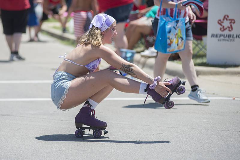Showing off her mad skills, a skater representing the Rink in Mt Morris glides through the Petunia parade Sunday, July 3, 2022.
