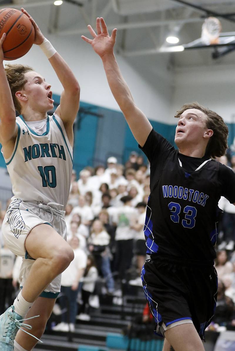 Woodstock North's Trevor Mark drives to the basket against Woodstock's Samuel Chapman during a Kishwaukee River Conference boys basketball game on  Friday, Jan. 5. 2024, at Woodstock North High School.