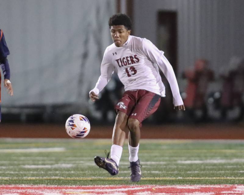 Plainfield North's Eli Bell (13) kicks the ball during Class 3A Naperville Central Regional semifinal soccer match between Plainfield North at Oswego, Tuesday Oct 21, 2025.