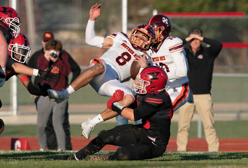 Yorkville's Blake Kersting (40) upends Brother Rice's Jack Lausch (8) during a a 7A state football playoff game at Yorkville High School on Saturday, Nov 6, 2021.