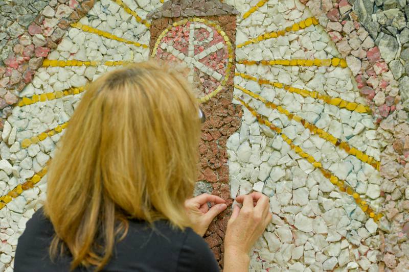 Volunteer Chris Alimenti works on the restoration of the Geneva Grotto on Thursday, June 15, 2023.