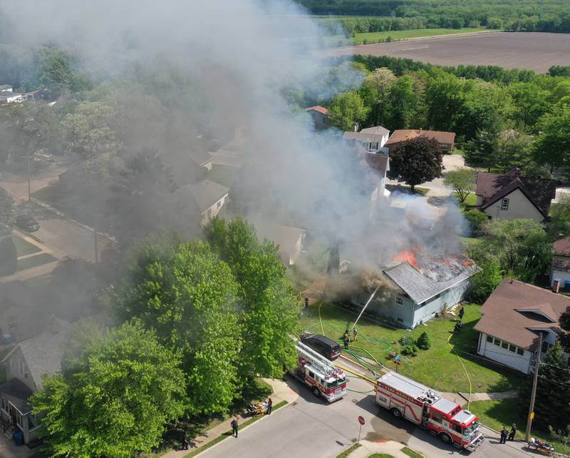 An aerial view of a structure fire as flames pour out of the roof in the 1900 block of Main Street on Monday, May 4, 2026 in Peru.
