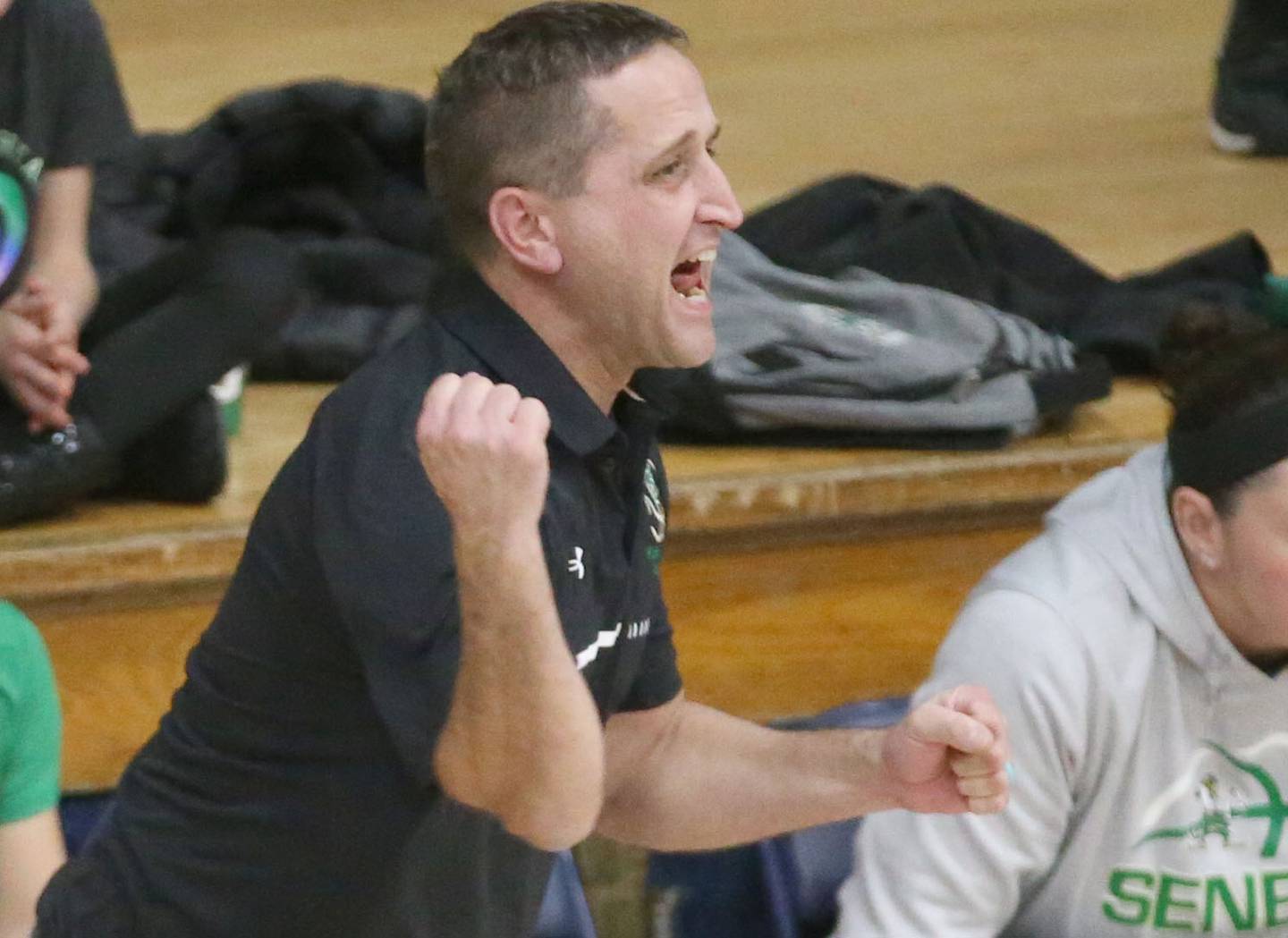 Seneca girls basketball coach Josh Myers reacts after a Fighting Irish player hits a shot against Marquette during a game this past season at Bader Gym.