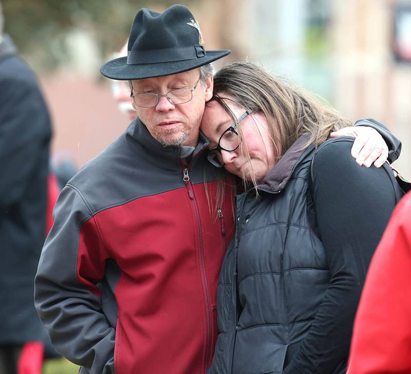 Joe Dubowski, (left) father of shooting victim Gayle Dubowski, hugs Stephanie Bonier, who grew up as friends with his daughter Gayle, during a remembrance ceremony Tuesday, Feb. 14, 2023, at the memorial outside Cole Hall at Northern Illinois University for the victims of the mass shooting in 2008. Tuesday marked the 15th year since the deadly shooting took place on campus which took the lives of five people.