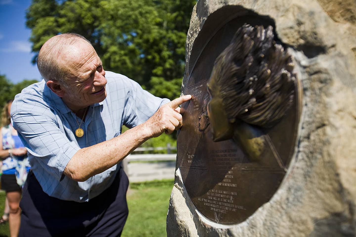 Samuel Harris, president of the Illinois Holocaust Museum and Education Center, looks at the sculpture that was dedicated to Lisa Derman on Sunday, July 31, 2011, in Spring Grove. Derman passed during an Illinois Storytelling Festival while telling her story of the Holocaust.