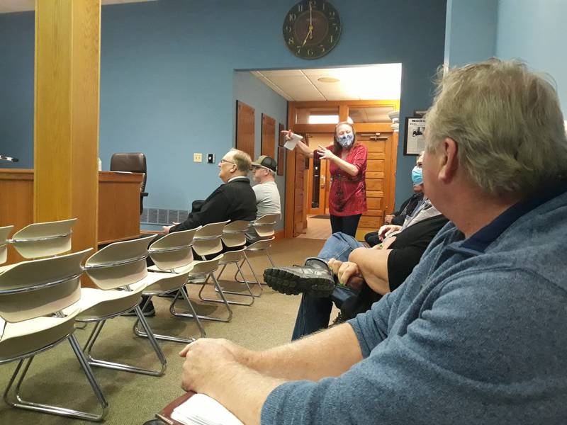 Jenelle Manfredini, who lives near Nick's on 6, explains Monday, March 21, 2022, to Gary Hammers, Nick's on 6 owner, how the outdoor music at the business affects her at La Salle home.