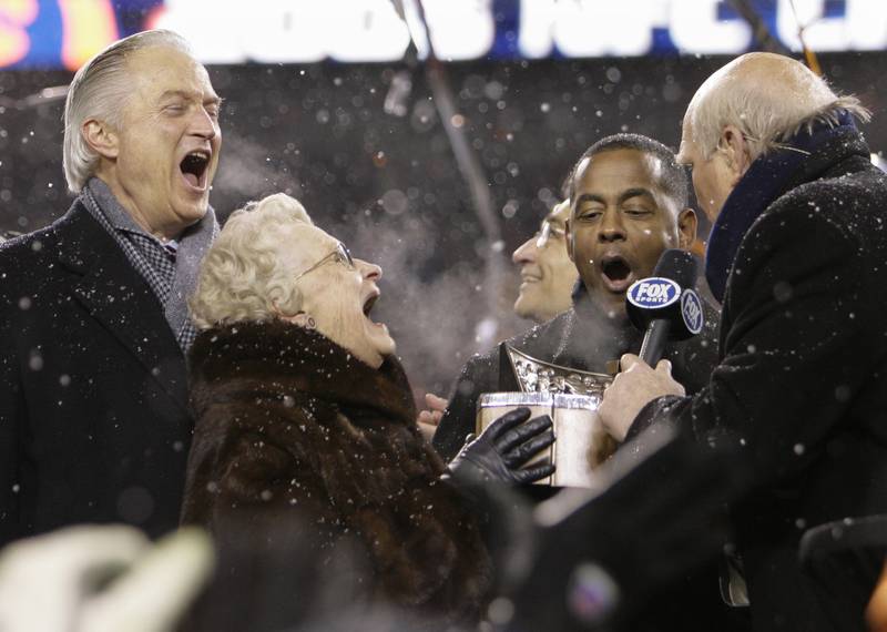FILE - In this Jan. 21, 2007, file photo, Chicago Bears owner Virginia McCaskey and Chairman of the Board Michael McCaskey, left, react as they are presented with the George S. Halas Trophy after the Bears' 39-14 NFL football win over the New Orleans Saints to win the NFC championship football game, in Chicago. Making the presentation are Fox broadcasters Tony Dorsett and Terry Bradshaw, right. Michael McCaskey, who led the Chicago Bears for nearly three decades following the death of his grandfather George Halas, died Saturday, May 16, 2020, after a lengthy battle with cancer, the team said. He was 76. (AP Photo/Alex Brandon, File)