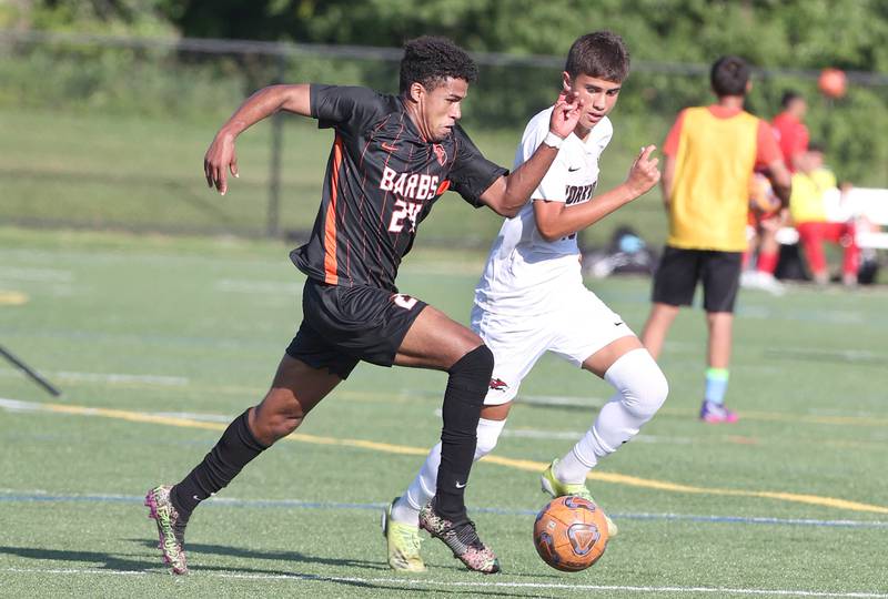 DeKalb's Josiah Antimo tries to sprint ahead of Yorkville's Mizael Terrazas during their game Thursday, Aug. 25, 2022, in the Barb Cup at the Northern Illinois University Outdoor Recreation Sports Complex.