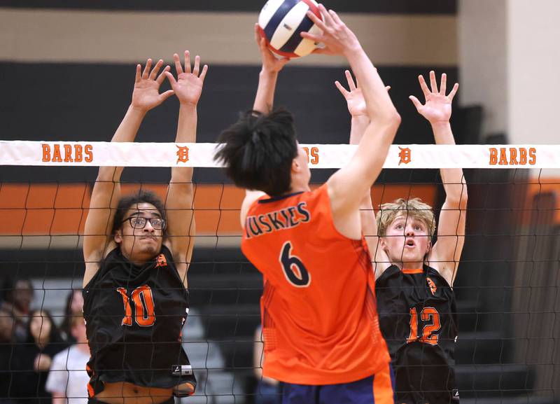 DeKalb’s Semaj Cooper (left) and Gregory Kubitz go up for a block Tuesday, April 21, 2026 during their match against Naperville North JV at DeKalb High School.