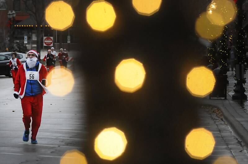 Danny Contreras runs towards the finish line during the McHenry County Santa Run For Kids Sunday morning, Dec. 5, 2021, in Downtown Crystal Lake. The annual event, which raises money for agencies in our county who work with children in need, had over 500 registered runners in the 5K and 1 mile run/walk.