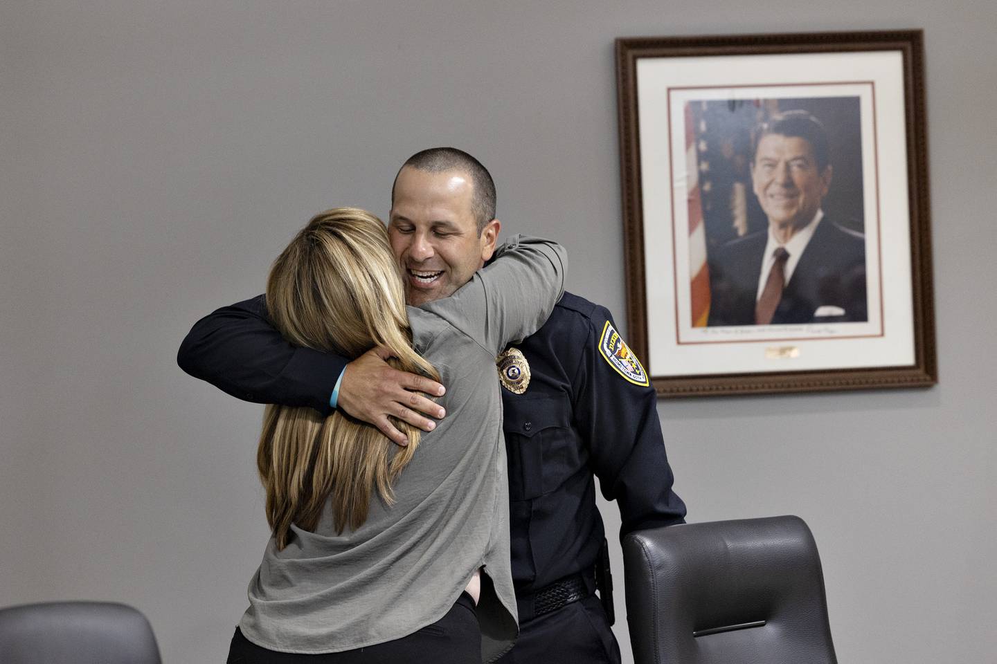 Aaron Simonton embraces Dixon City Council member Mary Oros on Monday, Aug. 18, 2025, after being sworn in as the new deputy chief.