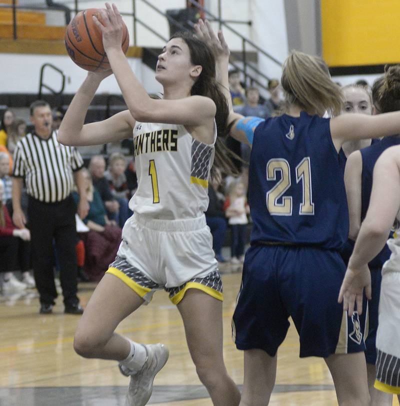 Putnam County’s Ava Hattongets gets past Marquette’s Avery Durdan to shoot in the 1st period on Wednesday, Dec. 14, 2022 at Putnam County High School.