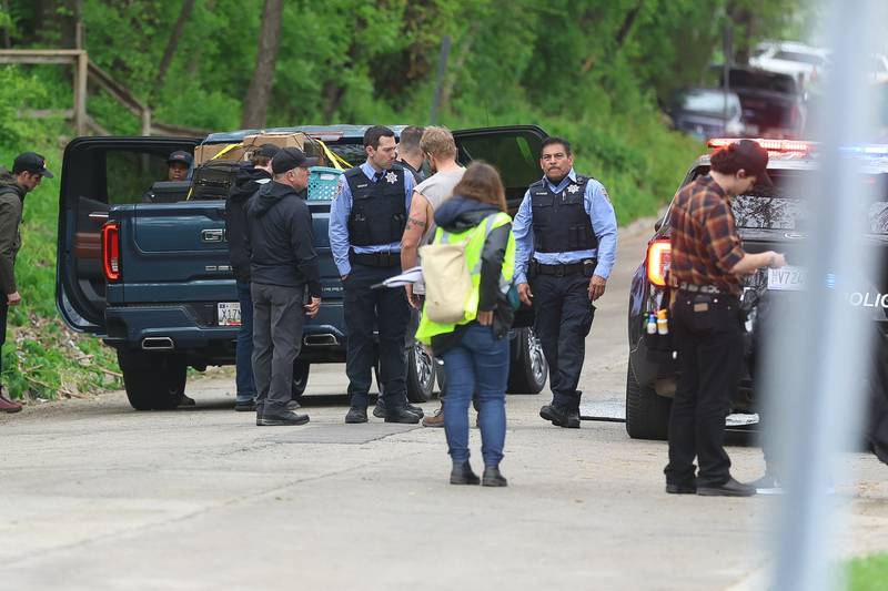 Actors wait along the 500 block of North Bluff street between filming on Monday, April 27, 2026 in Joliet. HBO began filming the pilot for “American Blue” that follows a police chief retuning to Joliet to take over the police department.