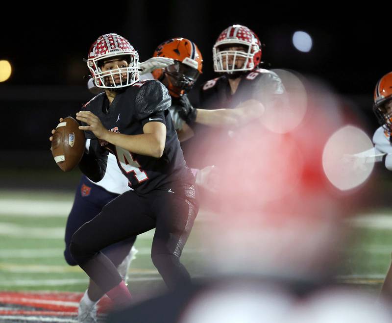 Maine South's Constantine Coines (14) looks for an open teammate against Evanston Friday October 20, 2023 in Park Ridge.