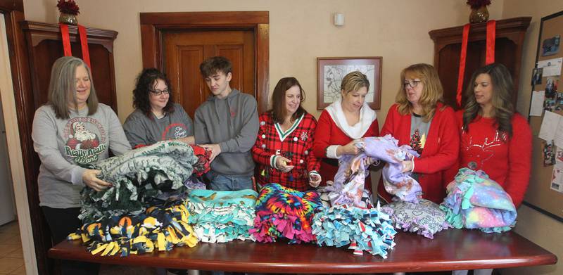 Candace H. Johnson for Shaw Local News Network
April Soulak-Andrews, of Antioch, (3rd from the right) president and founder, has a group of board members and volunteers to help her fold donated no-sew fleece blankets to be gifted to recipients for those in need during The Penny’s Purpose Annual Blanket Drive in Antioch. (12/17/22)