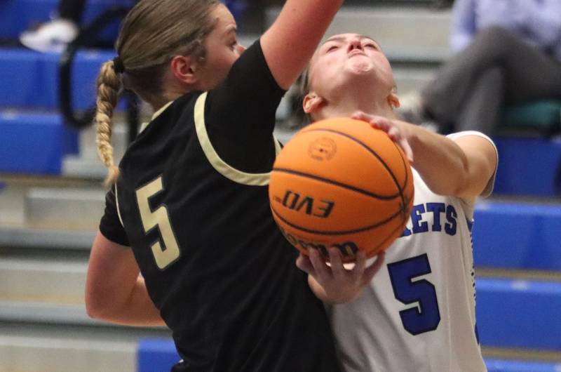 Burlington Central’s Audrey Lafleur, right, fights under the basket as Sycamore’s Grace Amptmann defends in girls basketball at Burlington Central High School in Burlington on Tuesday, November 18, 2025.