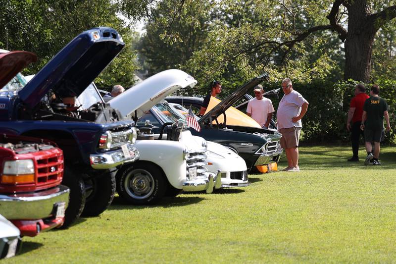 People check out the vintage and customer vehicles at the Crest Hill Lions Luau and Car Show on Sunday, Sept. 1, 2024 in Crest Hill.