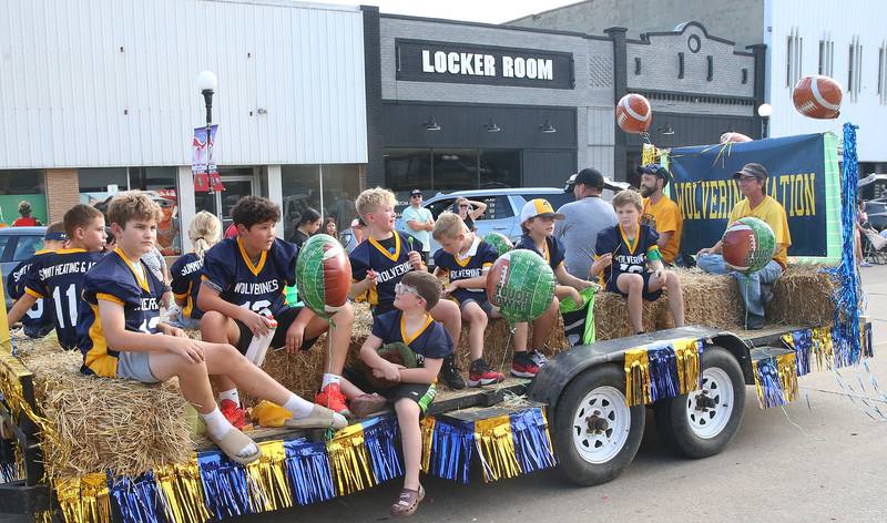 The Wolverines flag football team rides during the Homecoming parade on Thursday, Sept. 18, 2025 downtown Spring Valley.