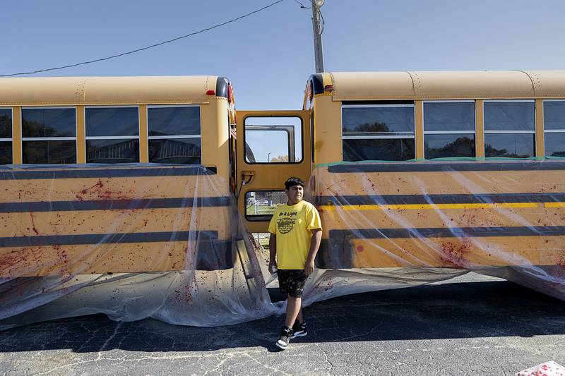 Rock Falls High School Junior Optimist volunteer Jovani Pedroza, 14, works the haunted school bus Oct. 22, 2022 at First Student in Rock Falls.