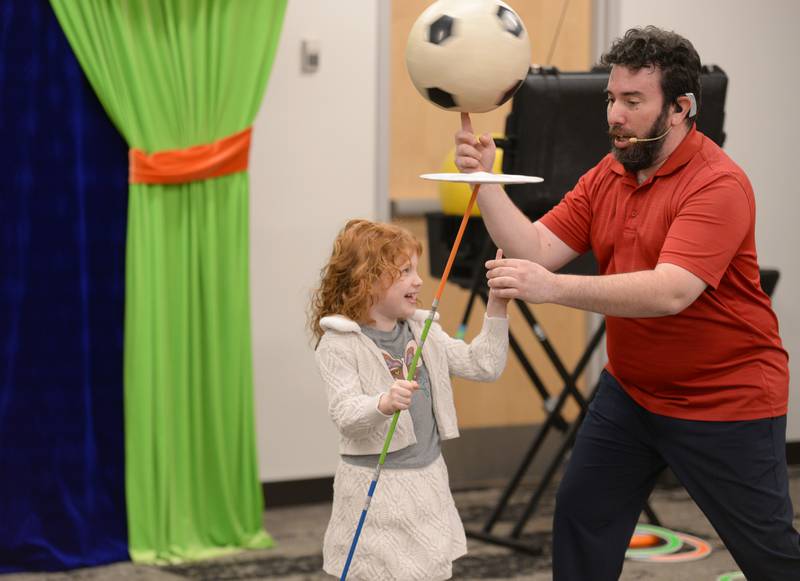 Helena Cerovac of Glen Ellyn and Jason Kollum  demonstrate how to juggle during the See a Juggler, Be a Juggler held at the Glen Ellyn Library Saturday April 5, 2025.