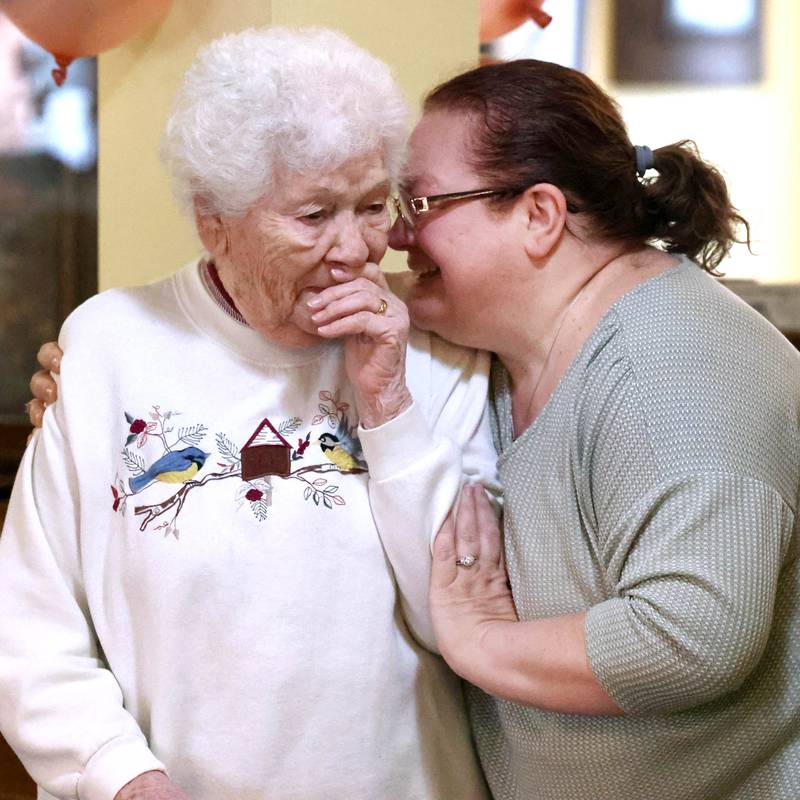 Heritage Woods of DeKalb resident Phyllis Fawcett, is hugged by Kimberly Lutz, director of nursing, as she becomes emotional upon being surprised by her friends and family for her 100th birthday Thursday, March 21, 2024, at Heritage Woods.