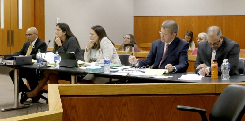 Defendant Carlos Acosta, defense attorney Rebecca Lee, defense attorney Jamie Wombacher, defense attorney Matthew McQuaid, and defendant Andrew Polovin listen to testimony during the fourth day of the trial for the former Illinois Department of Children and Family Services employees Acosta and Polovin before Lake County Judge George Strickland on Thursday, Sept. 14, 2023, at the McHenry County Courthouse. Acosta, 57, of Woodstock, and Polovin, 51, of Island Lake, each are charged with two counts of endangering the life of a child and health of a minor, Class 3 felonies, and one count of reckless conduct, a Class 4 felony, related to their handling of the AJ Freund case.