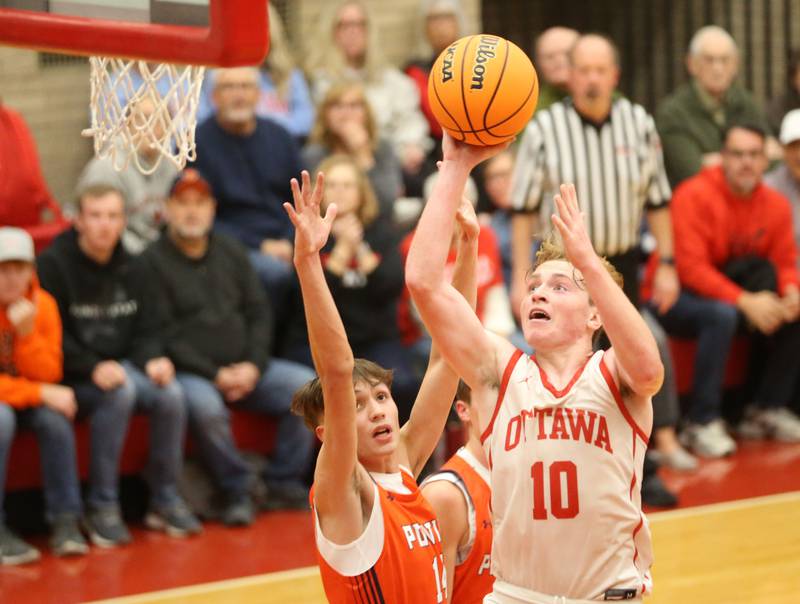 Ottawa's Evan Snook hits the winning shot over Pontiac's Jeremy Melton during the Dean Riley Shootin' The Rock Thanksgiving Tournament on Monday, Nov. 25, 2024 in Kingman Gym at Ottawa High School.
