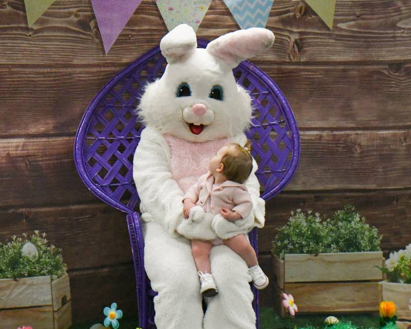 Grace Flasza, 11 months of Berwyn looks at the Easter bunny while sitting on his lap for a photo on Saturday March 29, 2025, during the breakfast with the bunny event held at the La Grange Park District Recreation Center.