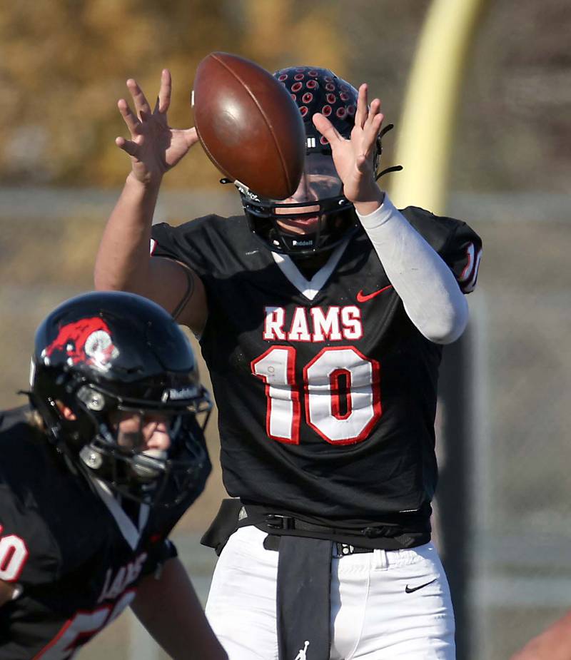 Glenbard East's Blake Salvino (10) receives the snap during the IHSA Class 7A quarterfinals Saturday November 11, 2023 in Lombard.