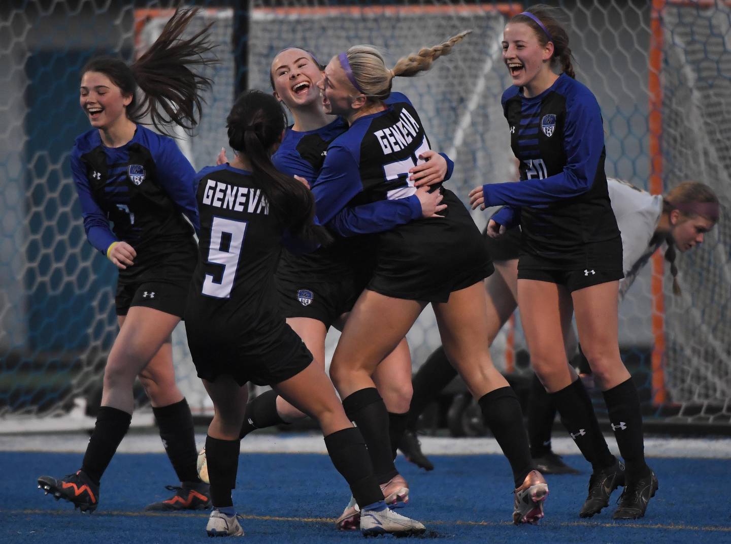 Geneva’s Julianna Drew is surrounded by teammates after her first-half goal against Neuqua Valley in a girls soccer game in Geneva on Thursday, March 23, 2023.